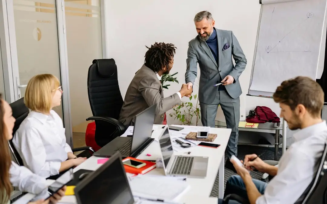 chefe cumprimentando homem de equipe