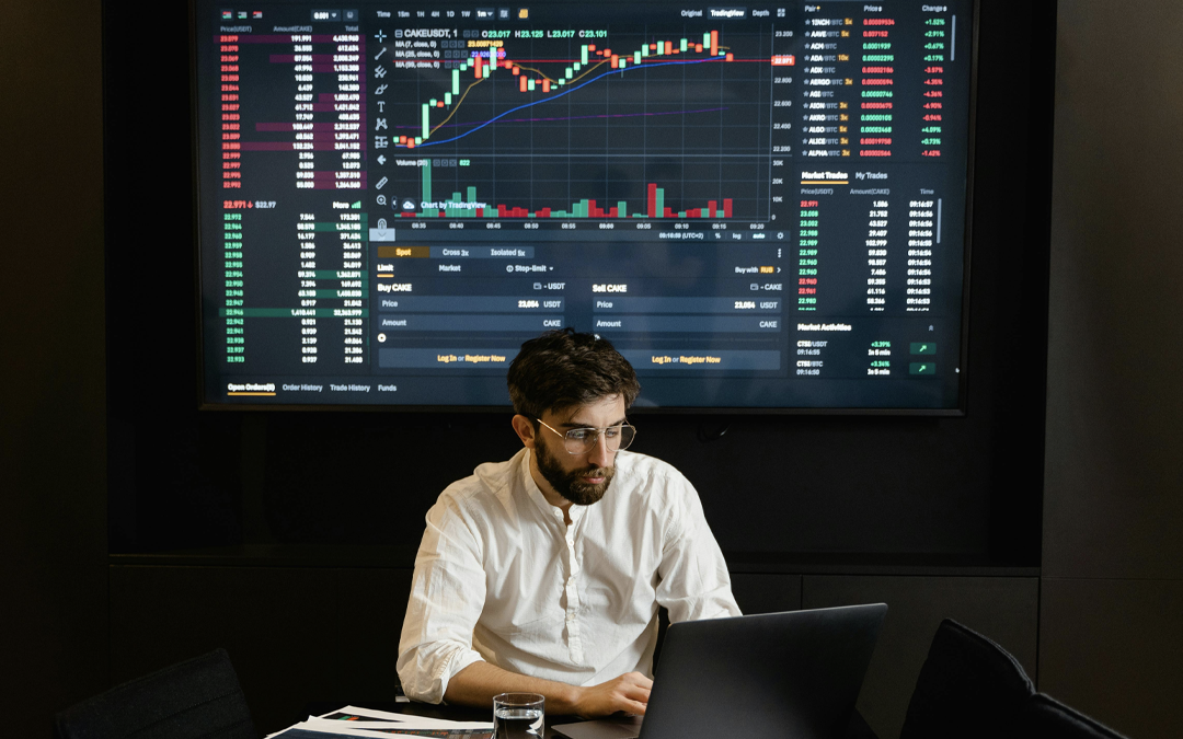 homem analisando dados com dashboard de gráficos em monitor atrás