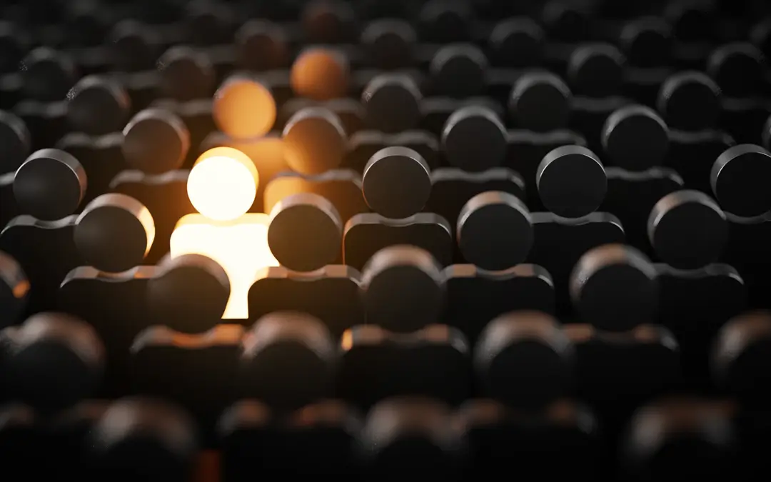 imagem ilustrativa de bonecos escuros com apenas um iluminado como escolhido